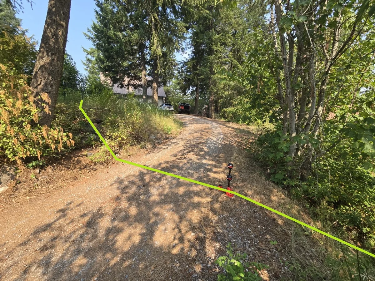 Sewer lateral located up a wooded driveway at a rural North Idaho property